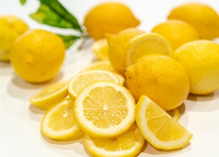 yellow lemon fruits on white surface