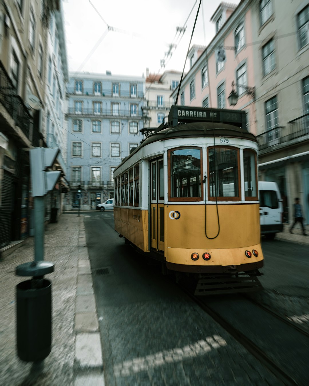 yellow tram on the street during daytime