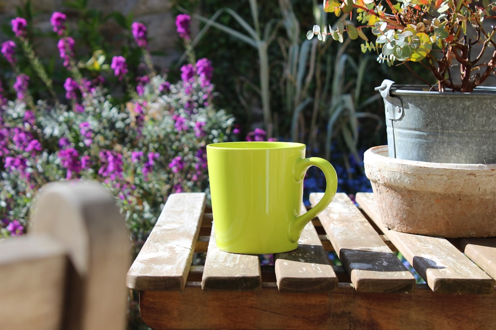 Taza de cerámica verde sobre mesa de madera marrón