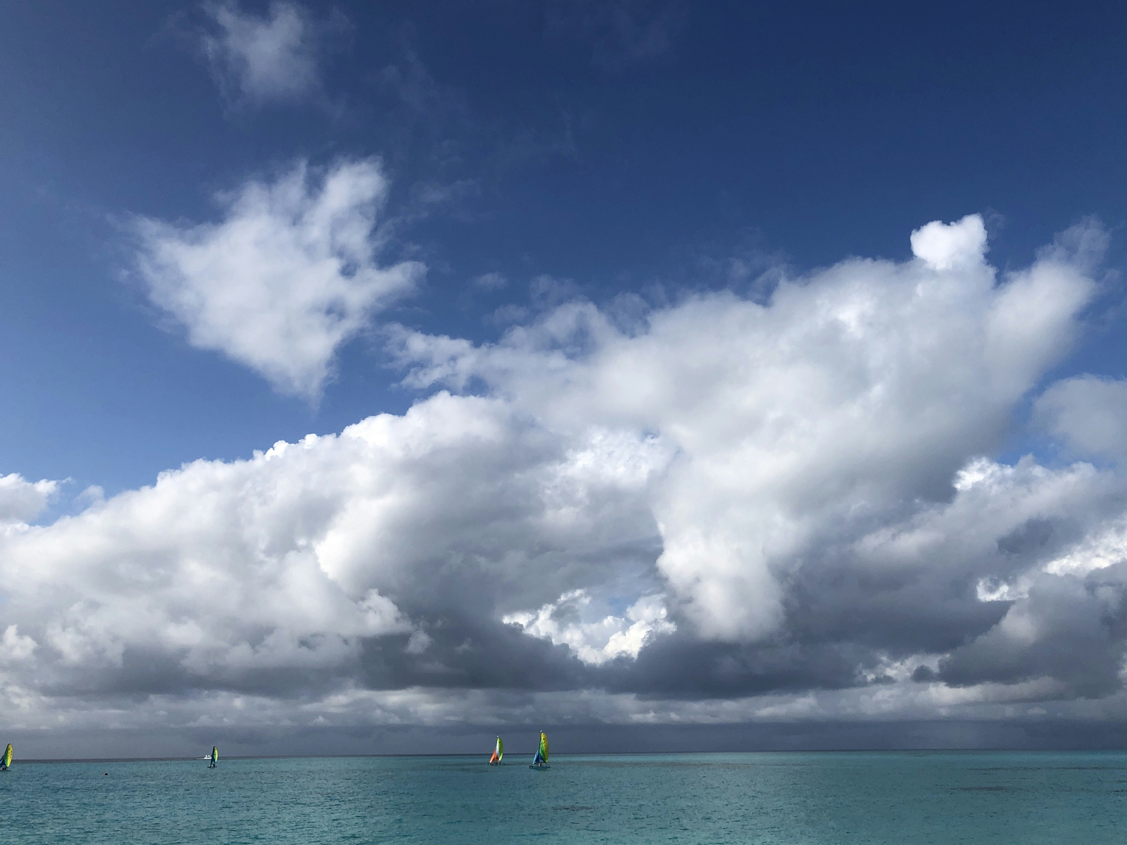 Blue sky and white clouds over sea photo – Free Blue Image on Unsplash