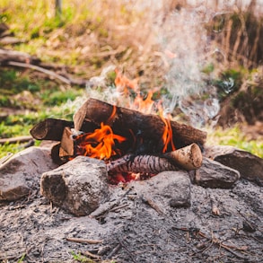 fire on gray rocks during daytime