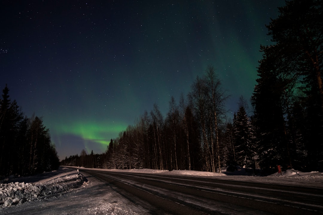 snow covered road during night time