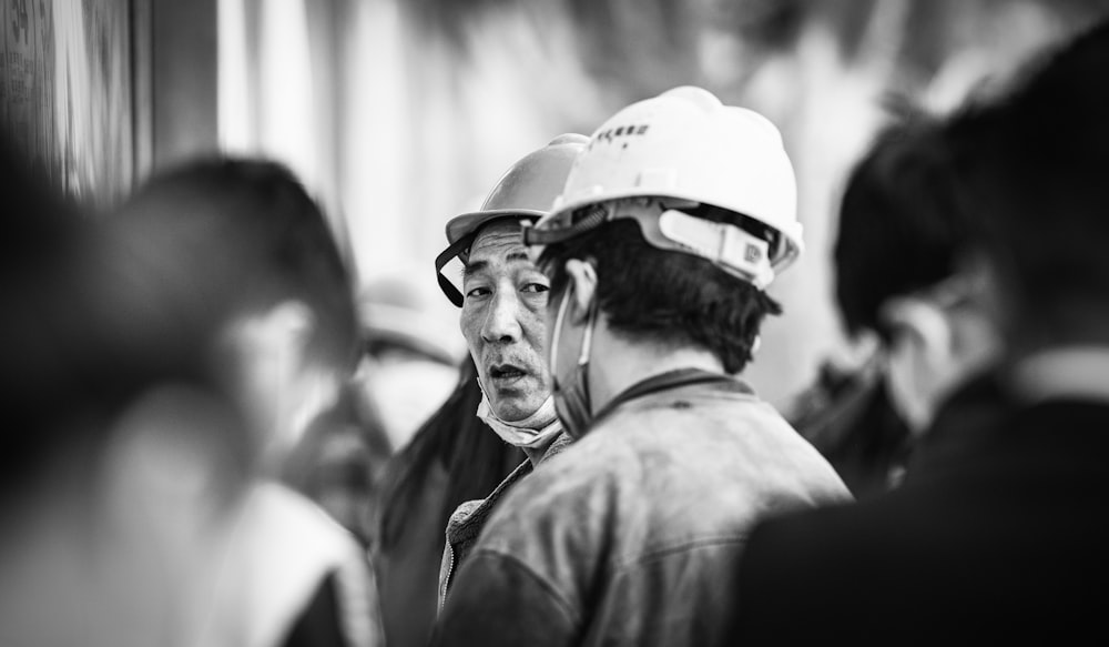 grayscale photo of man wearing helmet