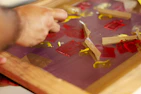 A contractor’s hands applying adhesive tape on a construction site beam.