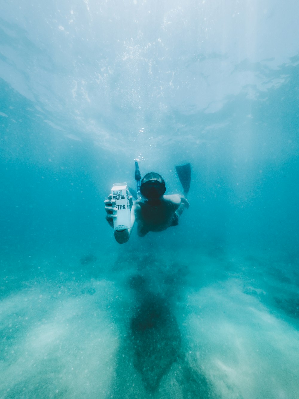 man in black diving suit under water