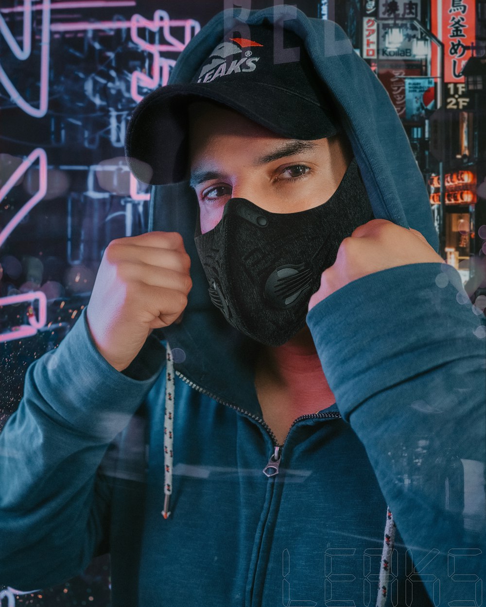 man in blue hoodie wearing black mask