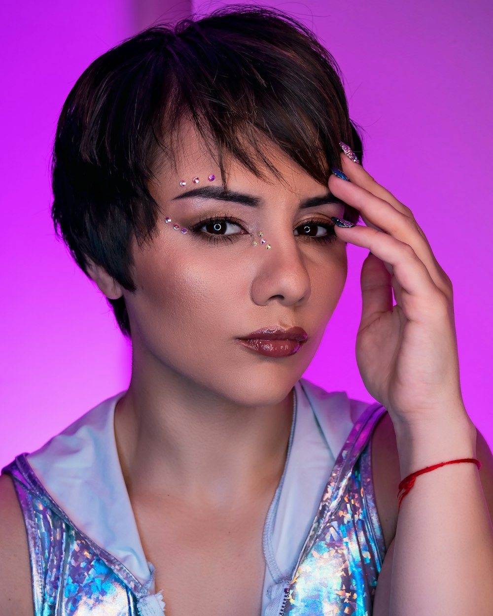 woman in white and blue floral shirt with purple background