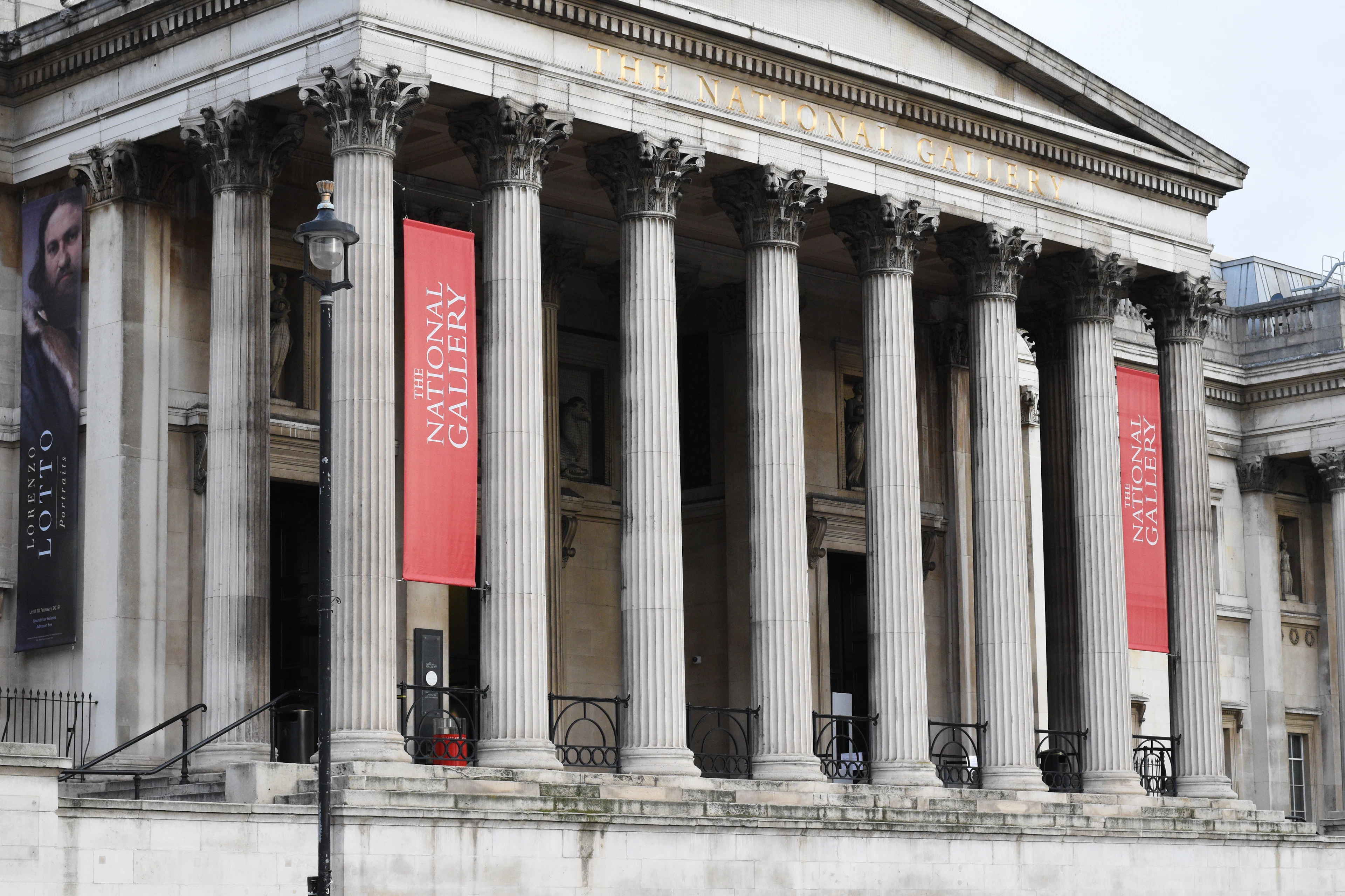 The portico of the National Gallery on Trafalgar Square, exhibition banners hung between its columns