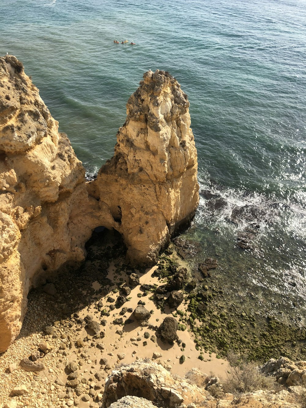 brown rock formation near body of water during daytime