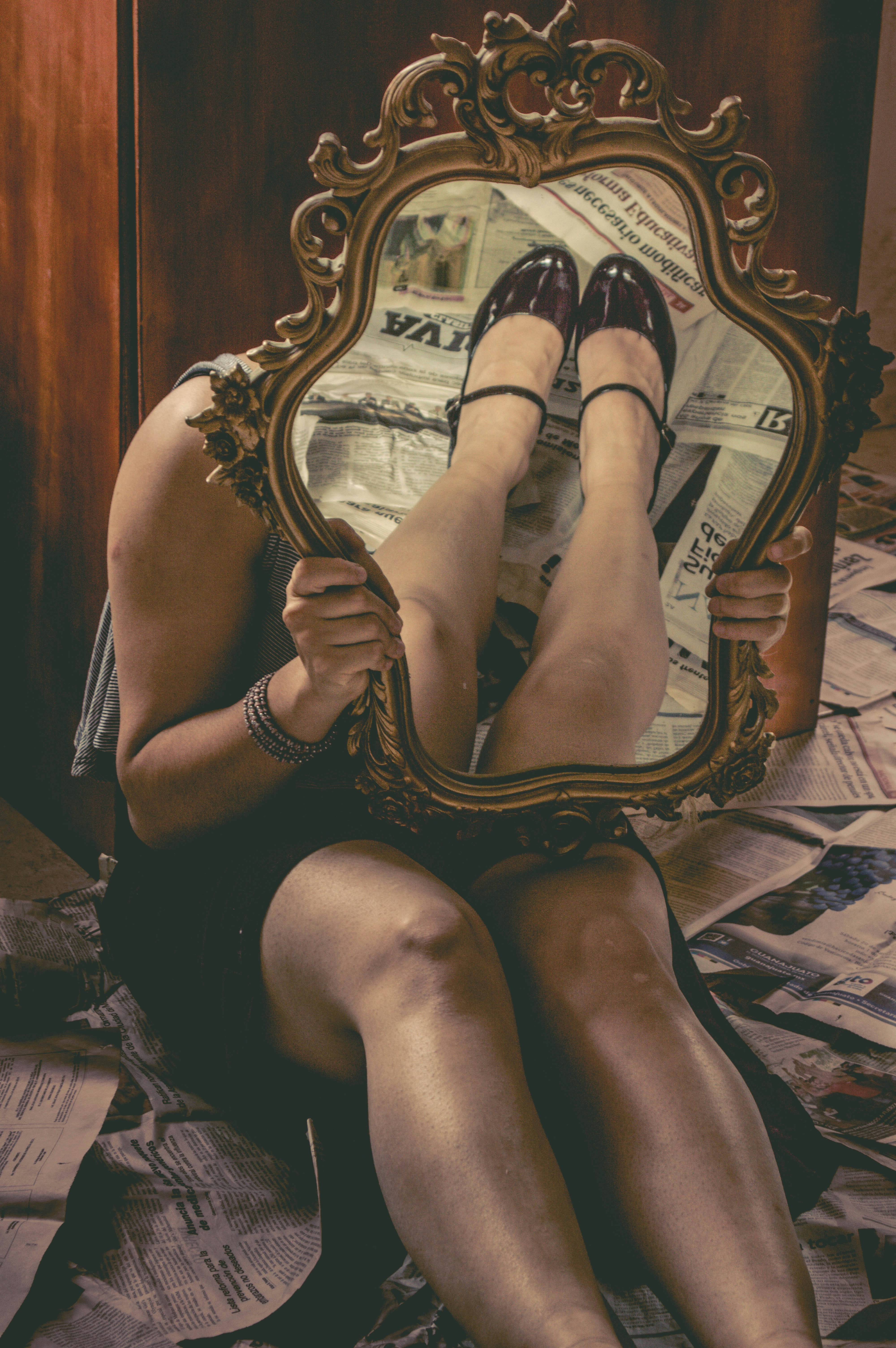 woman in black dress sitting on bed