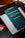 A book with a dark green cover is titled 'Iusnaturalismo y Positivismo Jurídico' by Norberto Bobbio is placed on top of a light-colored folder or book. There are colorful sticky note markers in pink, yellow, green, and blue on a dark surface next to the book.