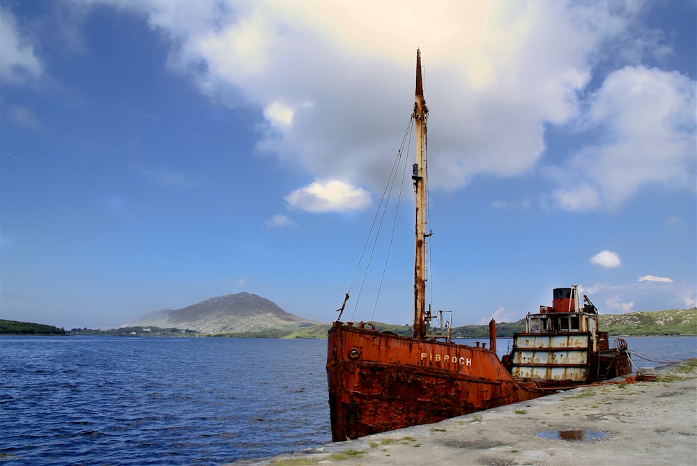 brown ship on sea under blue sky during daytime