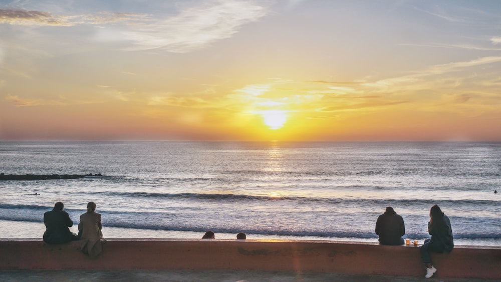 people on beach during sunset