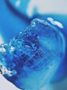 Ice machine producing fresh ice cubes with a soft blue light.