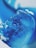 A close-up image of a blue ice cube with intricate textures and bubbles trapped within. The colors range from deep blue to lighter shades, creating a soothing and cool visual effect.