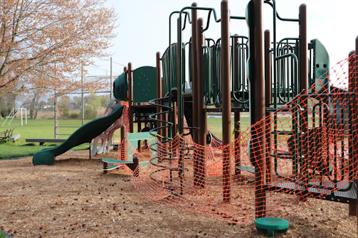 Wooden playground being installed with aluminum and iron supports.