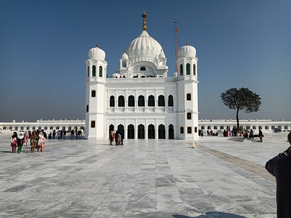 people walking on white concrete building during daytime