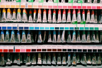 blue and white plastic bottle on white shelf