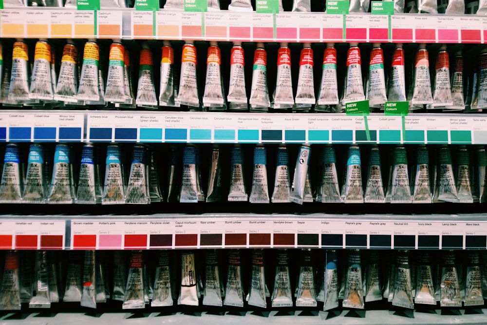 blue and white plastic bottle on white shelf