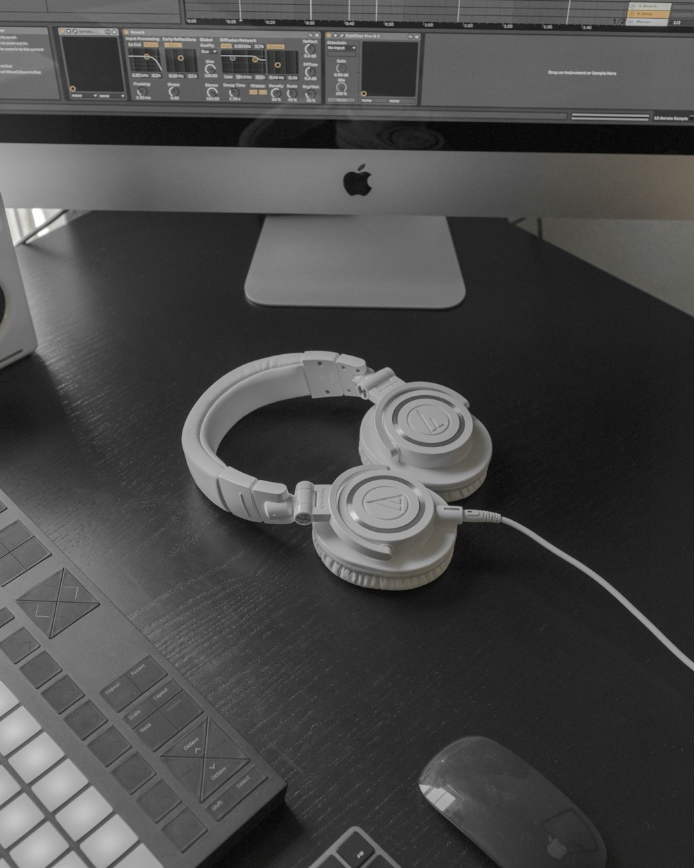 white and black headphones on black table