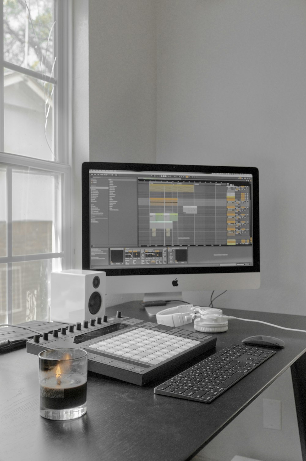 silver imac on table near window