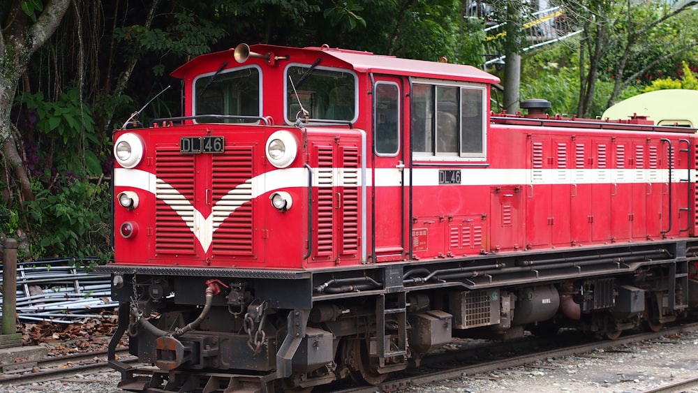 red and black train on rail tracks