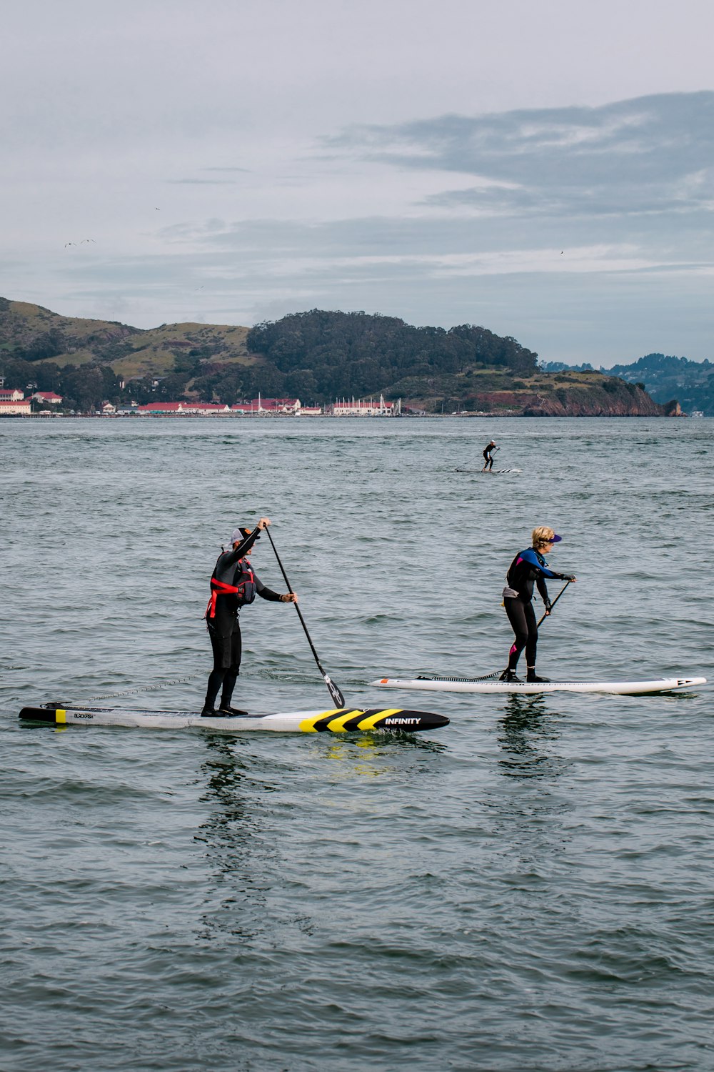 2 men riding yellow kayak on sea during daytime