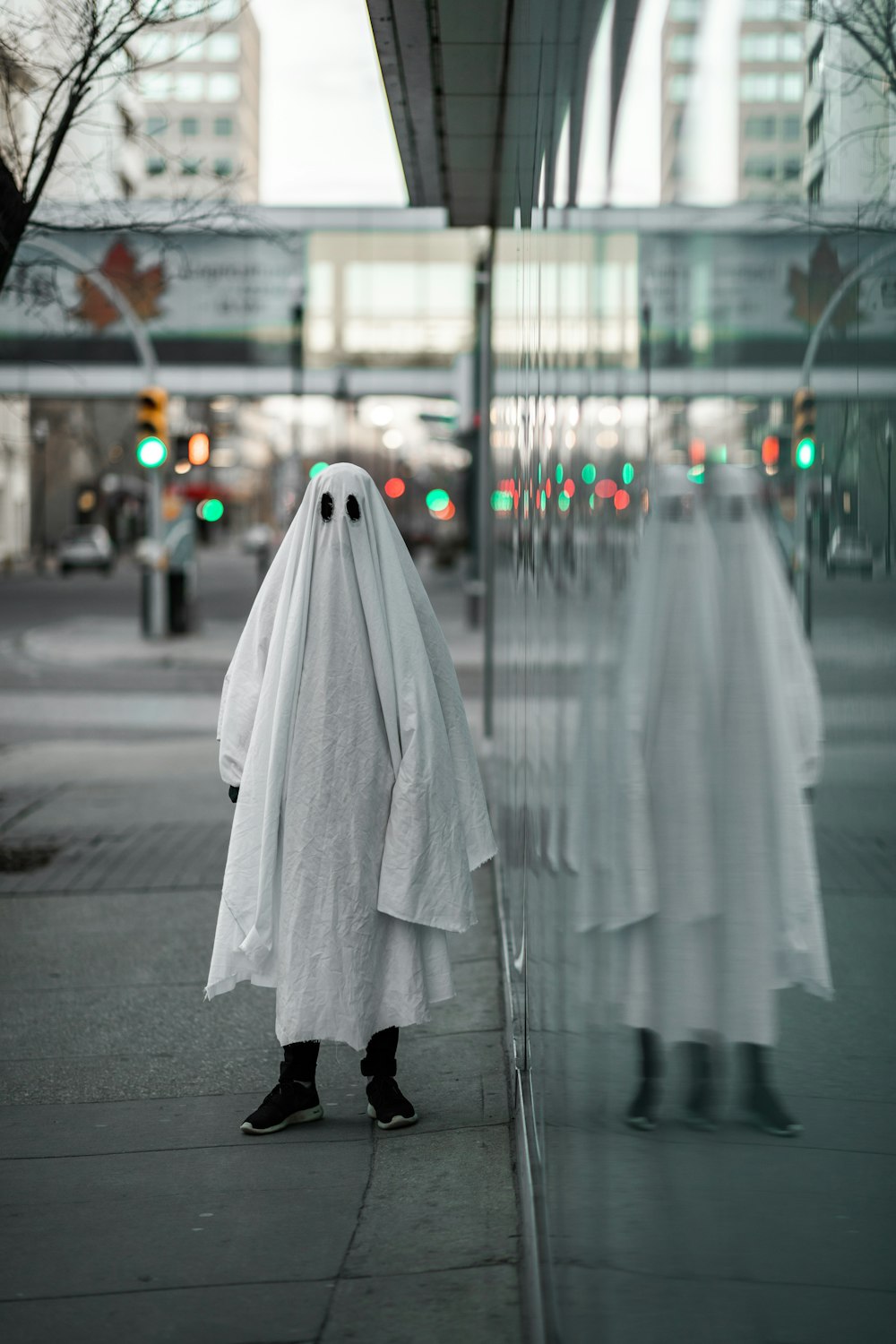 person in white robe standing on road during daytime