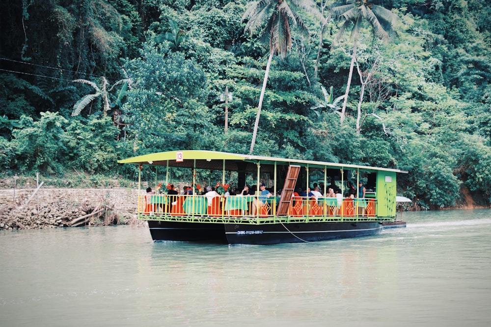 people riding on boat on river during daytime