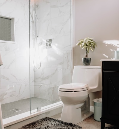 white ceramic toilet bowl beside white ceramic toilet bowl