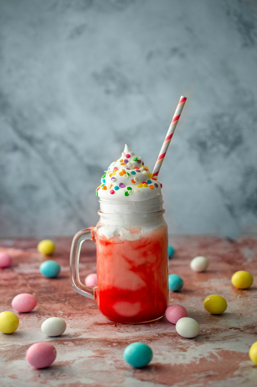 clear glass jar with white and red straw