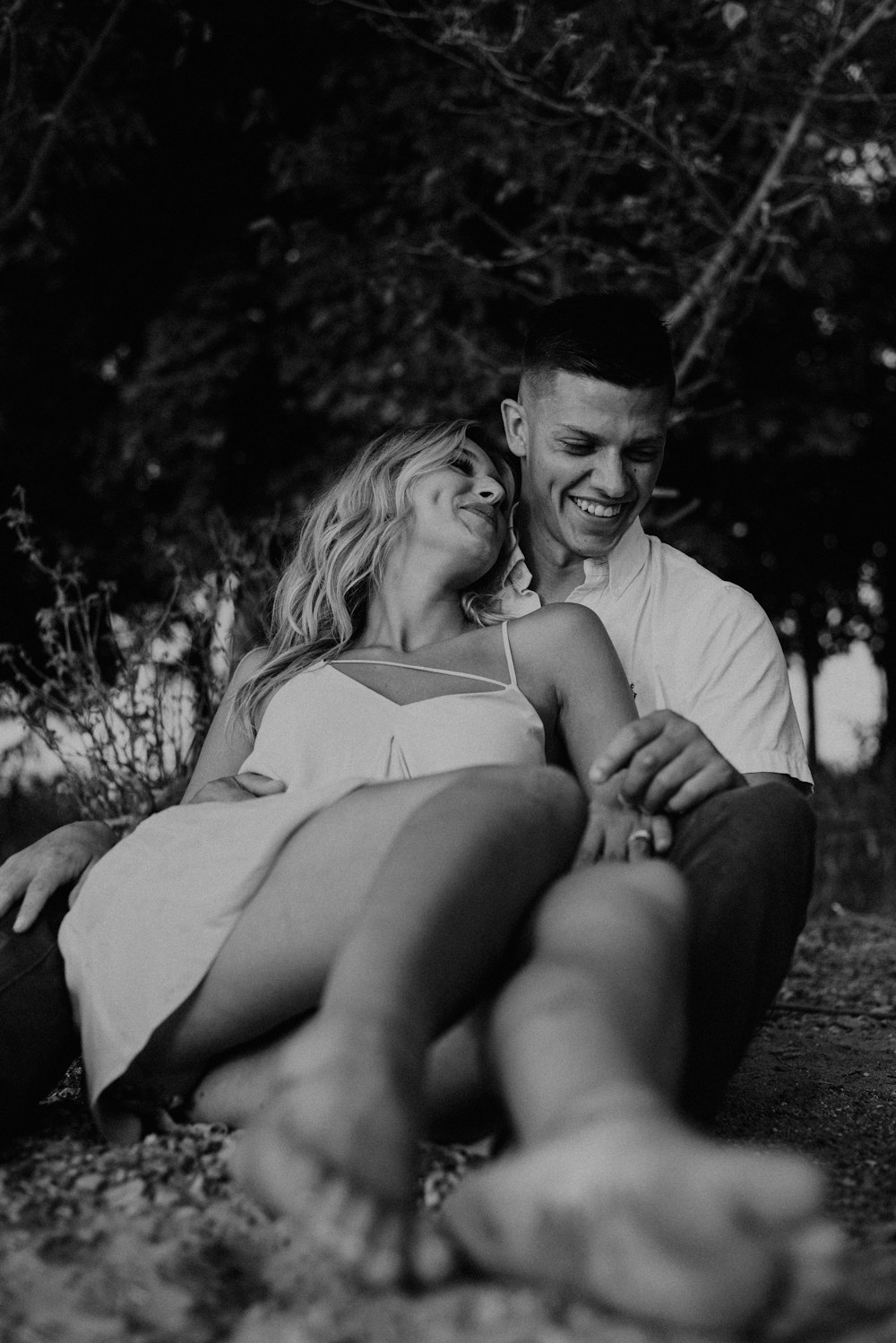 man and woman sitting on wooden bench