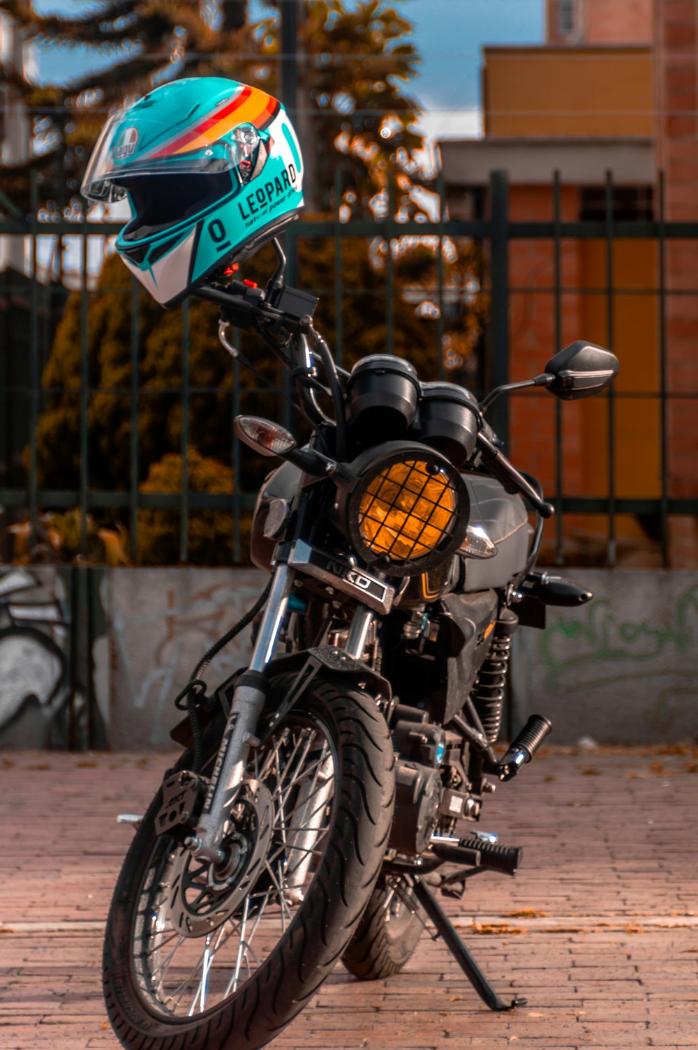 black motorcycle with blue and green cap