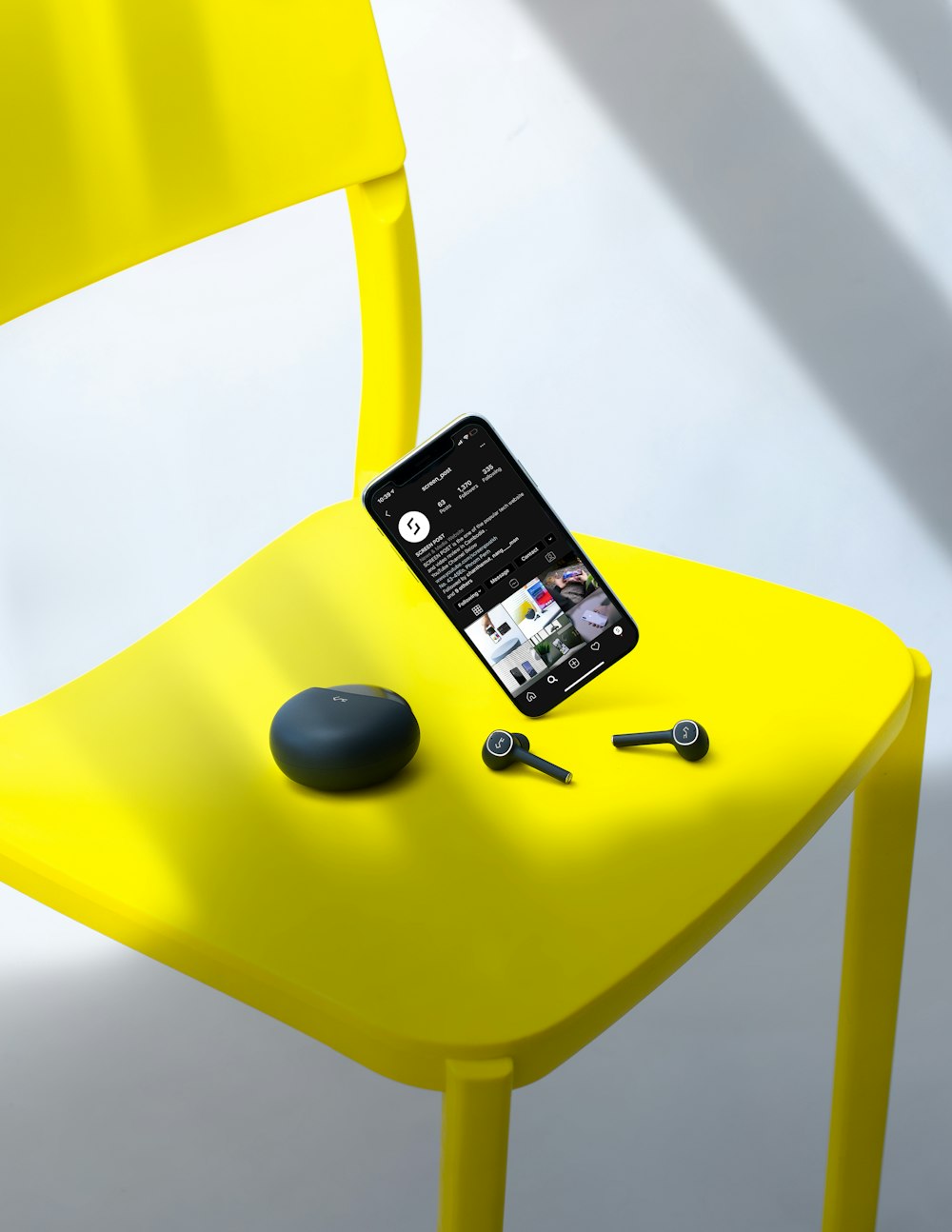 black iphone 4 on yellow chair