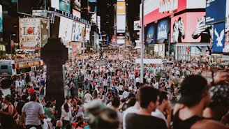 A bustling urban plaza filled with people using interactive digital kiosks branded with Publiwifi visuals.