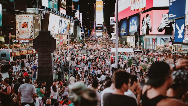 A bustling urban plaza filled with people using interactive digital kiosks branded with Publiwifi visuals.