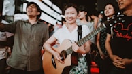 An outdoor guitar workshop with students engaging actively.