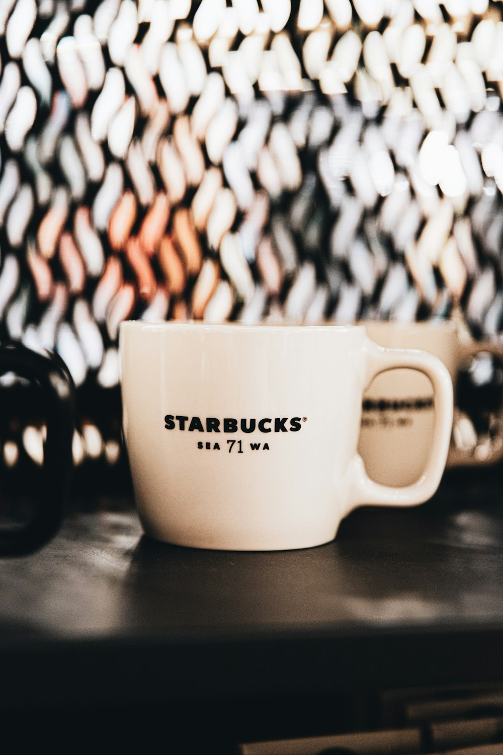 a white coffee cup sitting on top of a table