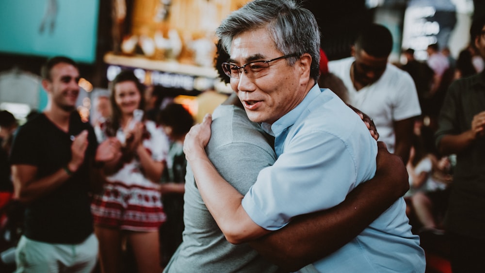 man in white polo shirt wearing black framed eyeglasses