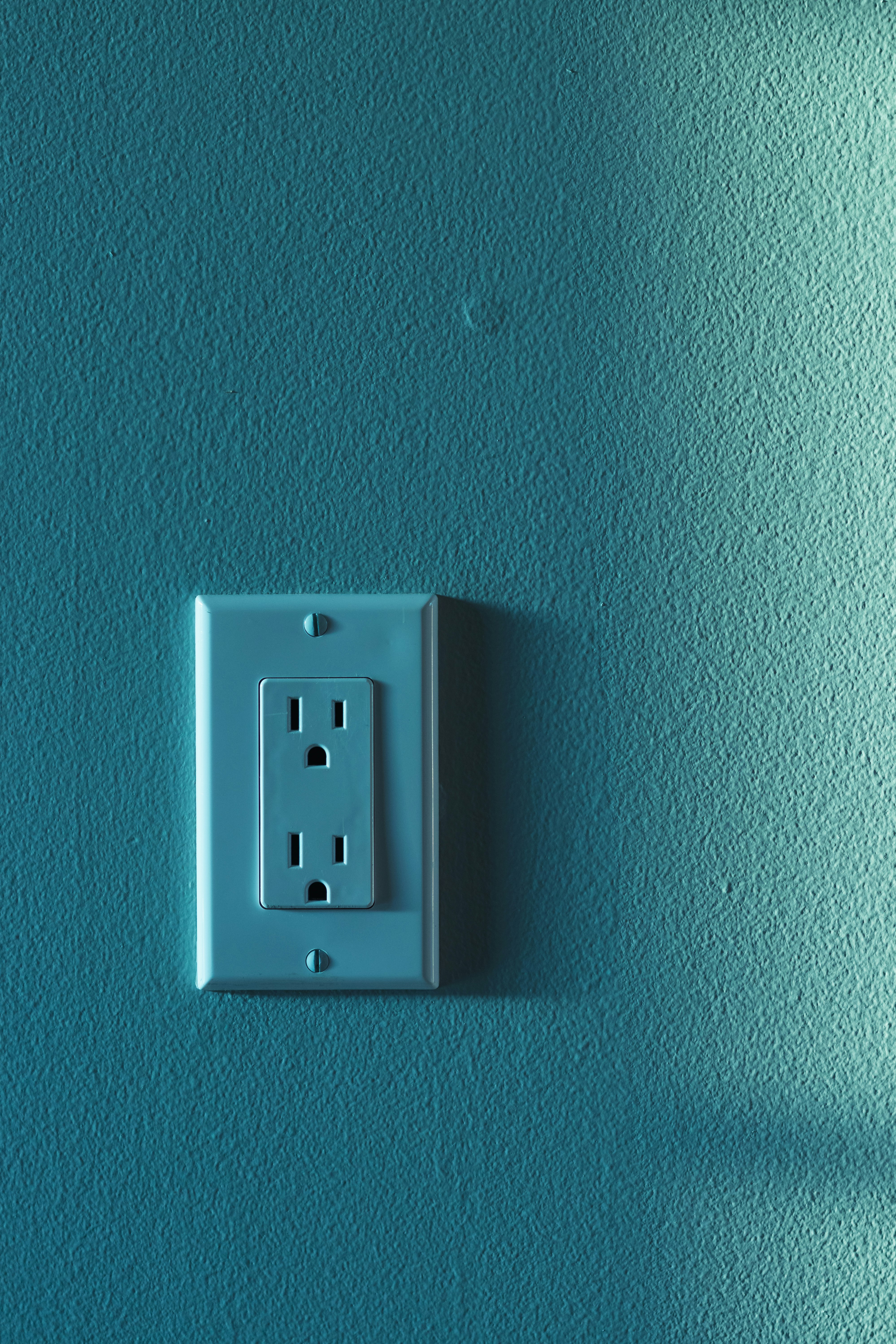 electrical wall socket vertical with textured paint and blank space