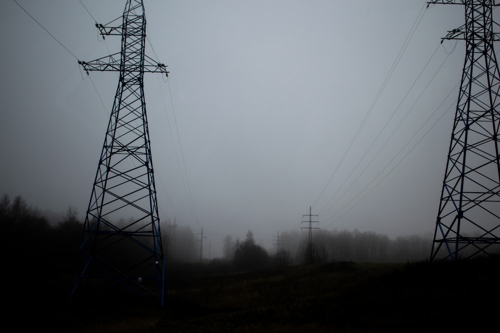 black electric tower on green grass field