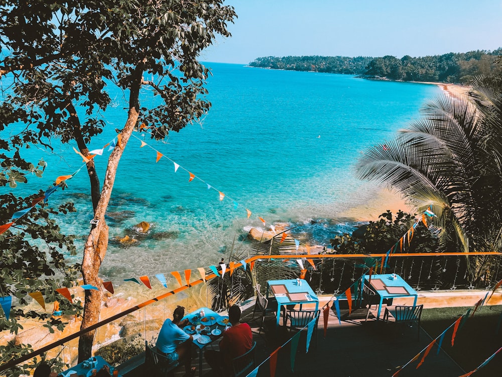 people swimming on beach during daytime