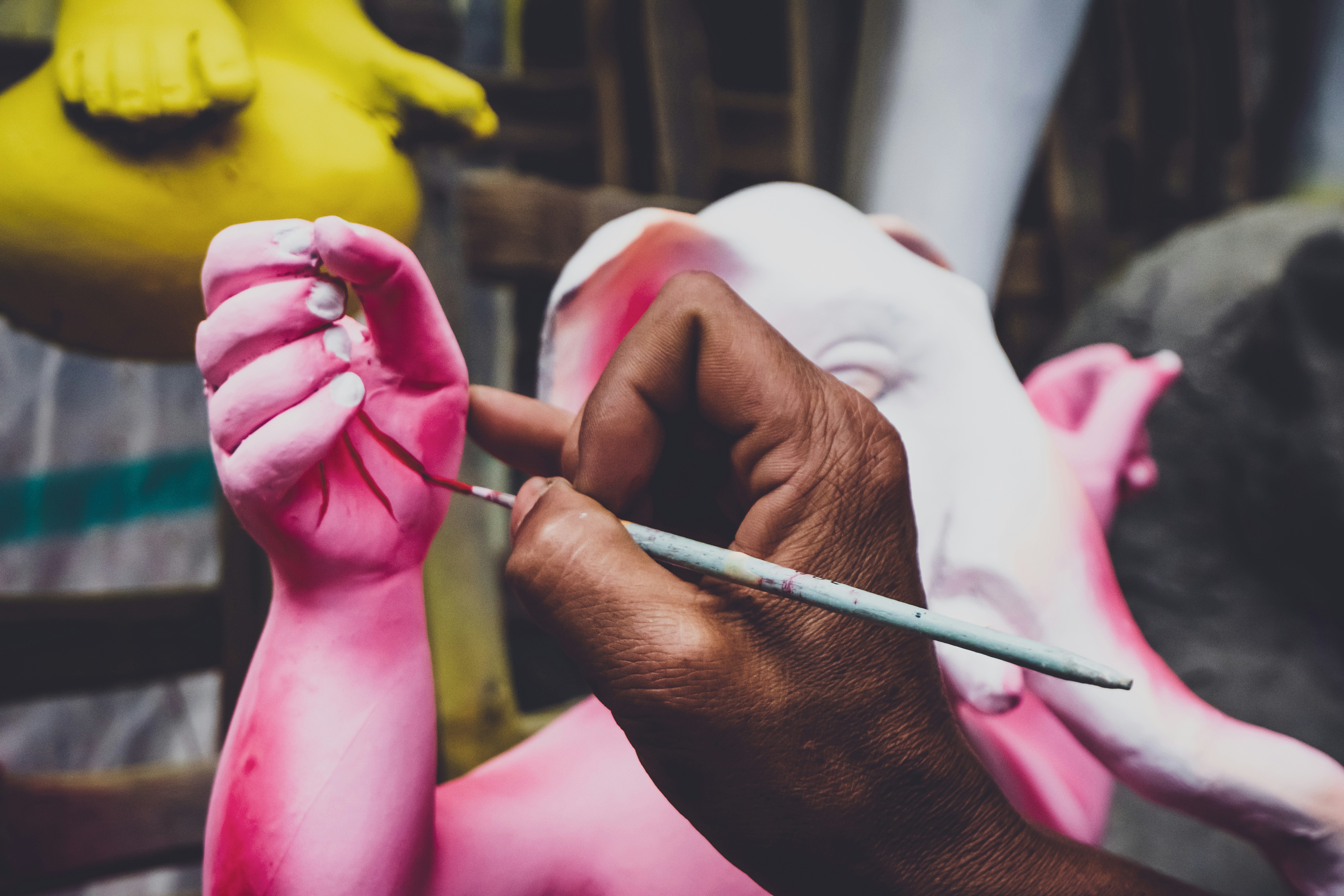 person holding white paint brush