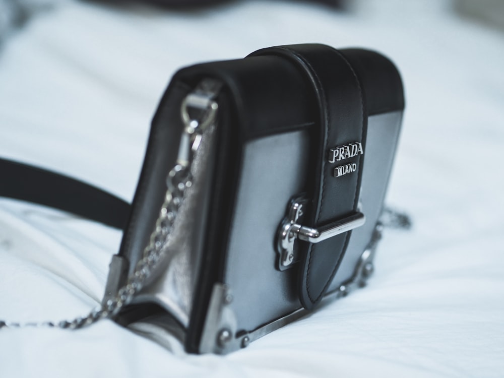 black leather handbag on white textile