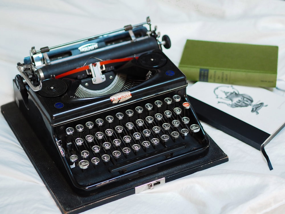 black and green typewriter on white table