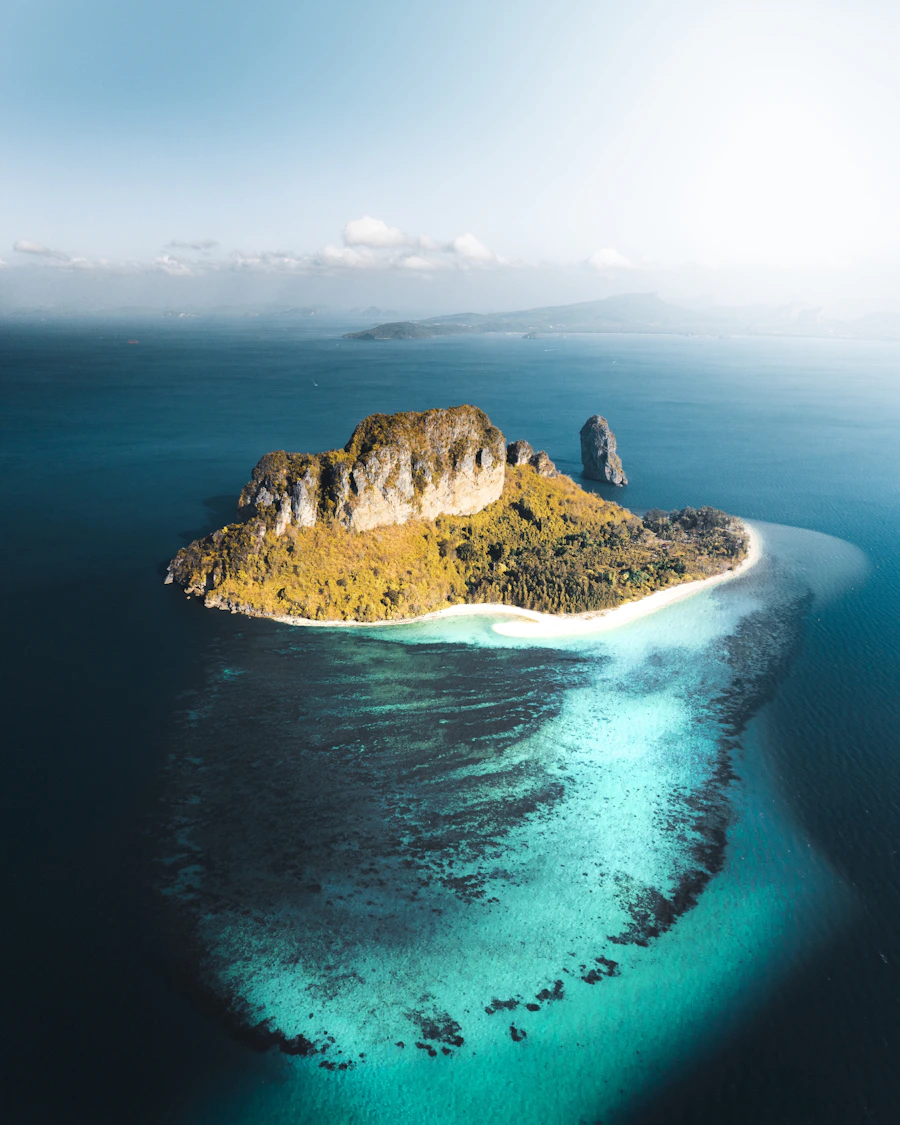 Bright coastal mountains beneath white clouds