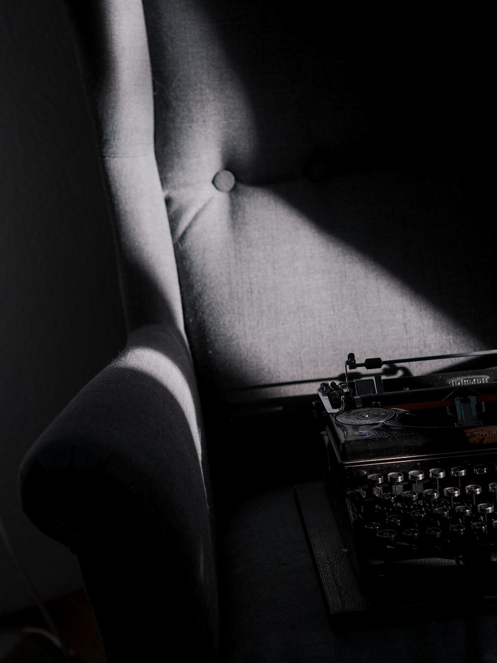 black typewriter on white sofa