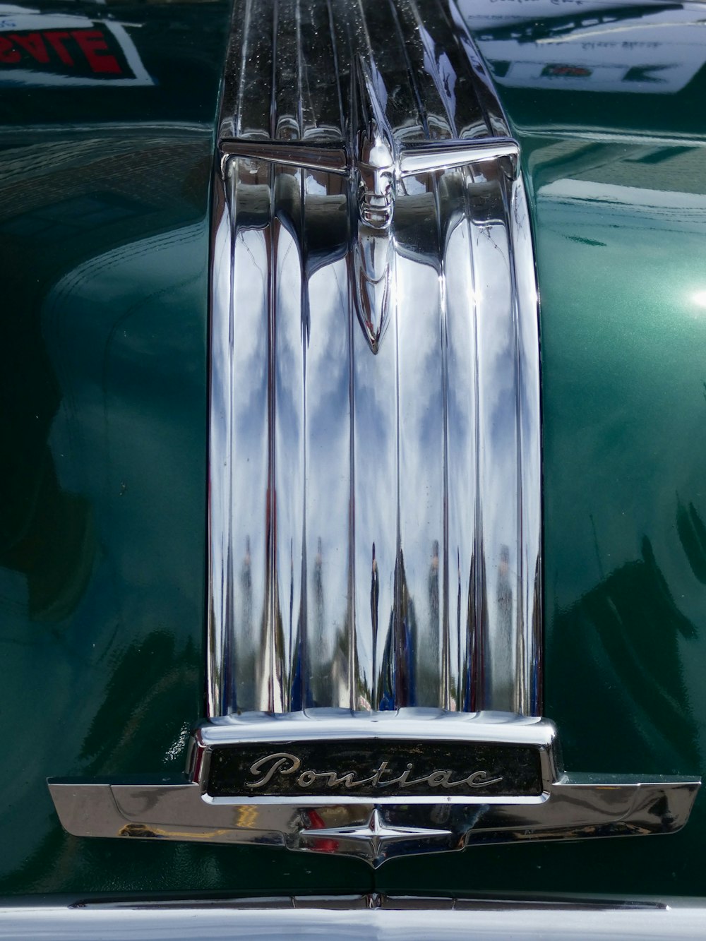 the front end of a green classic car