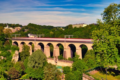 brown concrete bridge over river under cloudy sky during daytime
