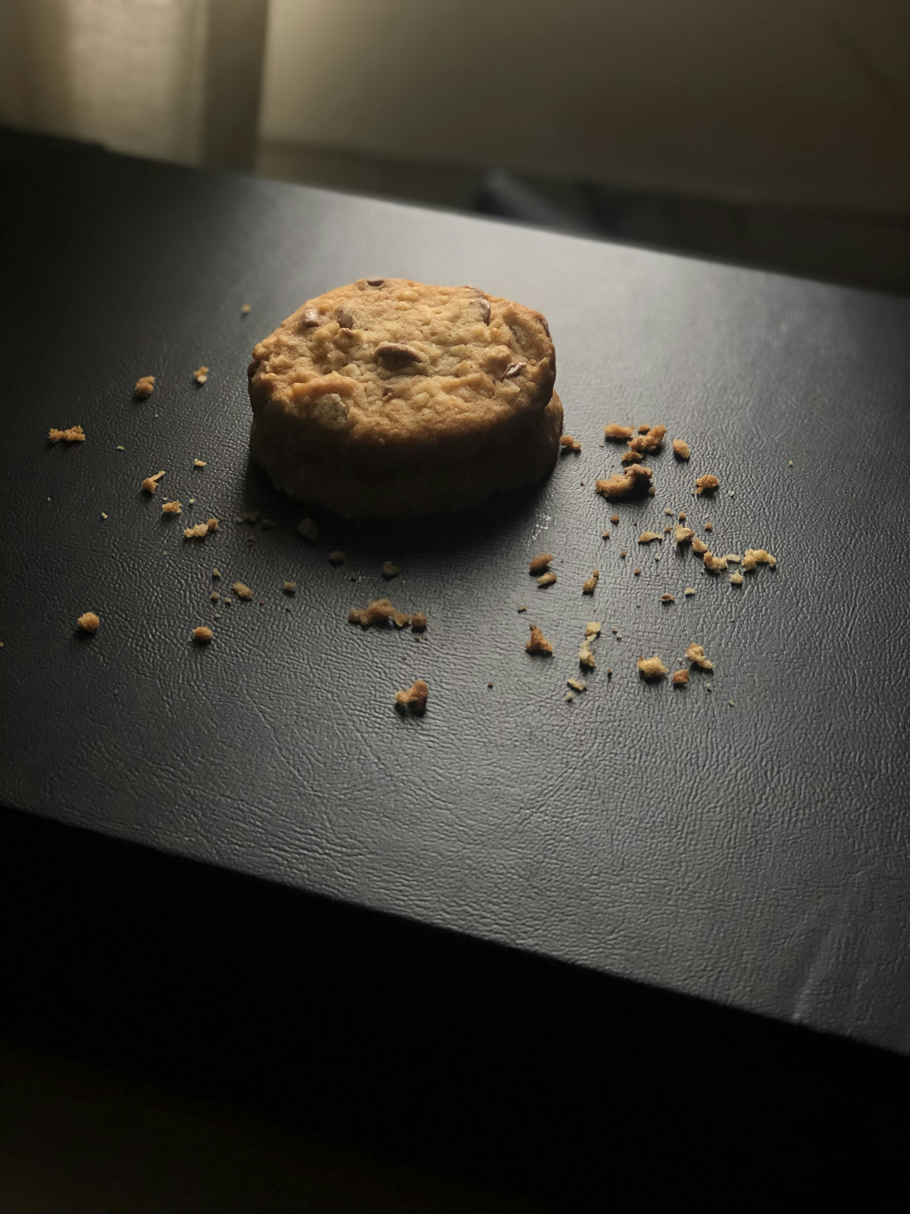 brown cookie on black leather textile